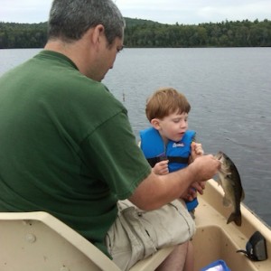 A young son sharing the catch of his first largemouth bass with his father is a special moment indeed.